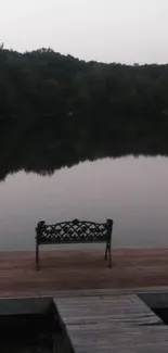 Tranquil dockside view with a lone bench at dusk.