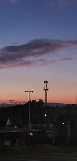 Beautiful sunset cityscape with lights illuminating the evening sky.