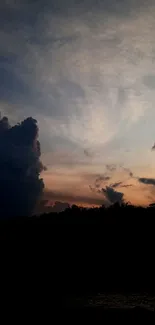 Serene evening sky with dark clouds and sunset hues.