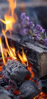 Wood burning with orange flames and purple flowers.