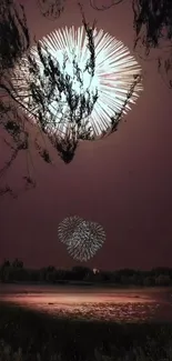 Fireworks light up a serene night over a tranquil lake.