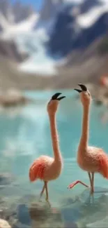 Two flamingos by a serene mountain lake with clear blue water.