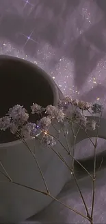 A lavender gray mug with flowers against a sparkly background.