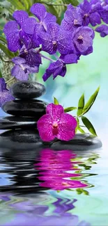 Zen stones and orchids with water reflection.