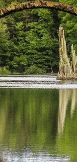 Beautiful forest lake and stone bridge reflected in serene waters.