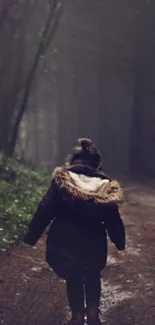 Person walking through a dark forest path on a misty day.