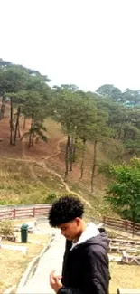 Young person walking in scenic forest pathway