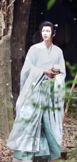 Person in traditional dress roaming a tranquil forest setting.