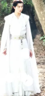 Majestic figure in a white robe standing in a tranquil forest.