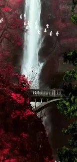 Serene waterfall with red forest and bridge.