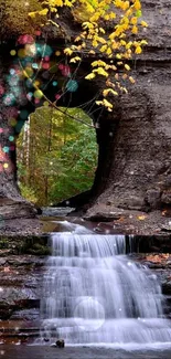 Forest waterfall with rocky formations and autumn leaves.