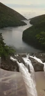 Serene waterfall amidst lush green forest and mountains.