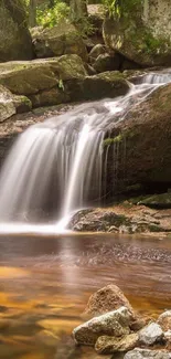 Serene waterfall in lush forest with rocks and flowing water.