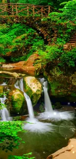 Tranquil waterfall with lush greenery and rustic wooden bridge in a serene forest.