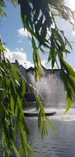 Serene fountain framed by green leaves on a sunny day.