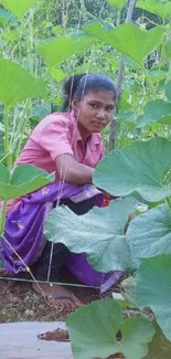 Person in a garden surrounded by lush green plants.