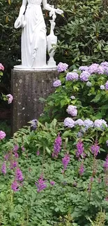 Elegant garden statue with purple flowers and lush greenery.