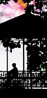 Silhouette of a person in a garden gazebo with floral backdrop.