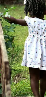 A young girl explores a lush green garden path.