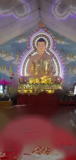 Golden Buddha statue in a shrine with vibrant decorations.