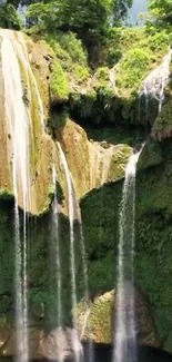 Serene waterfall in lush green forest wallpaper.