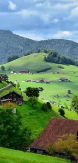 Mobile wallpaper of green hills and houses under a cloudy sky.