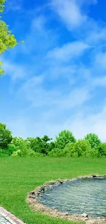 Green landscape with trees and a pond under a blue sky.