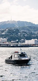 Serene boat on water with scenic hills in background.