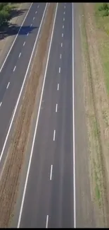 Aerial view of a serene highway surrounded by greenery.