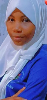 Portrait of a woman in a blue hijab and white scarf.