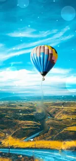 Hot air balloon floating over a scenic golden landscape under a vibrant blue sky.