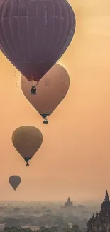 Hot air balloons floating at sunrise over temples.