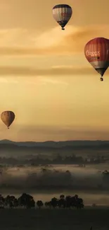 Hot air balloons floating over a misty, orange-toned landscape at dusk.