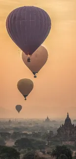 Hot air balloons ascend over a serene landscape under a warm sunrise.