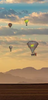 Hot air balloons over a serene desert landscape at sunset.