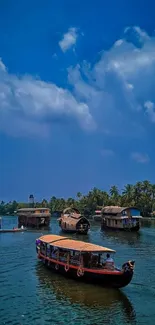 Houseboats on a serene lake under vibrant blue skies.