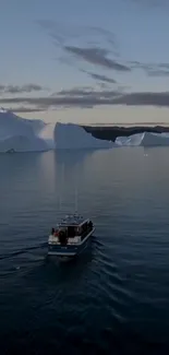 A boat on a serene ocean with icebergs under a blue sky.