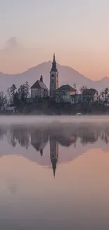 Island church reflected in a misty lake at dawn, serene wallpaper.