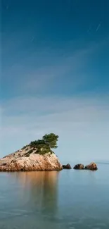 Serene island with blue sky and calm sea in mobile wallpaper.