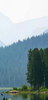 Kayaker on a serene lake with forest and mountains.