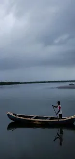 A lone boat drifts on a serene lake under a cloudy sky.