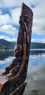 Intricate carved boat on a peaceful lake.