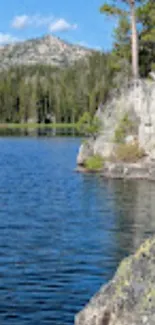 Serene lake and forest wallpaper with a distant mountain view.