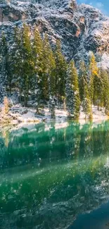 Serene forest lake with snow-covered trees reflecting in crystal-clear waters.