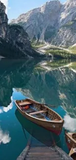 Peaceful mountain lake with wooden boats and reflections.