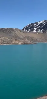 Turquoise lake with snowy mountains backdrop