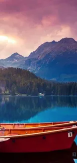 Red boats on a calm lake with mountain backdrop and dramatic sunset sky.