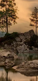 Serene sunset over a rocky lake with silhouetted trees.