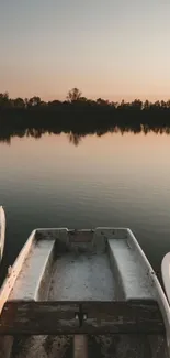 Three boats on a lake at sunset with trees in the background.