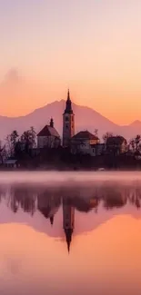 Serene sunset over a tranquil lake, reflecting a church silhouette.